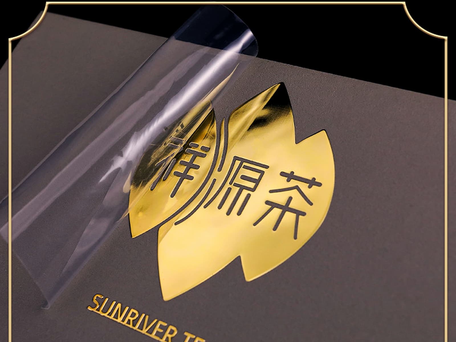 Gold UV transfer film being peeled from a logo